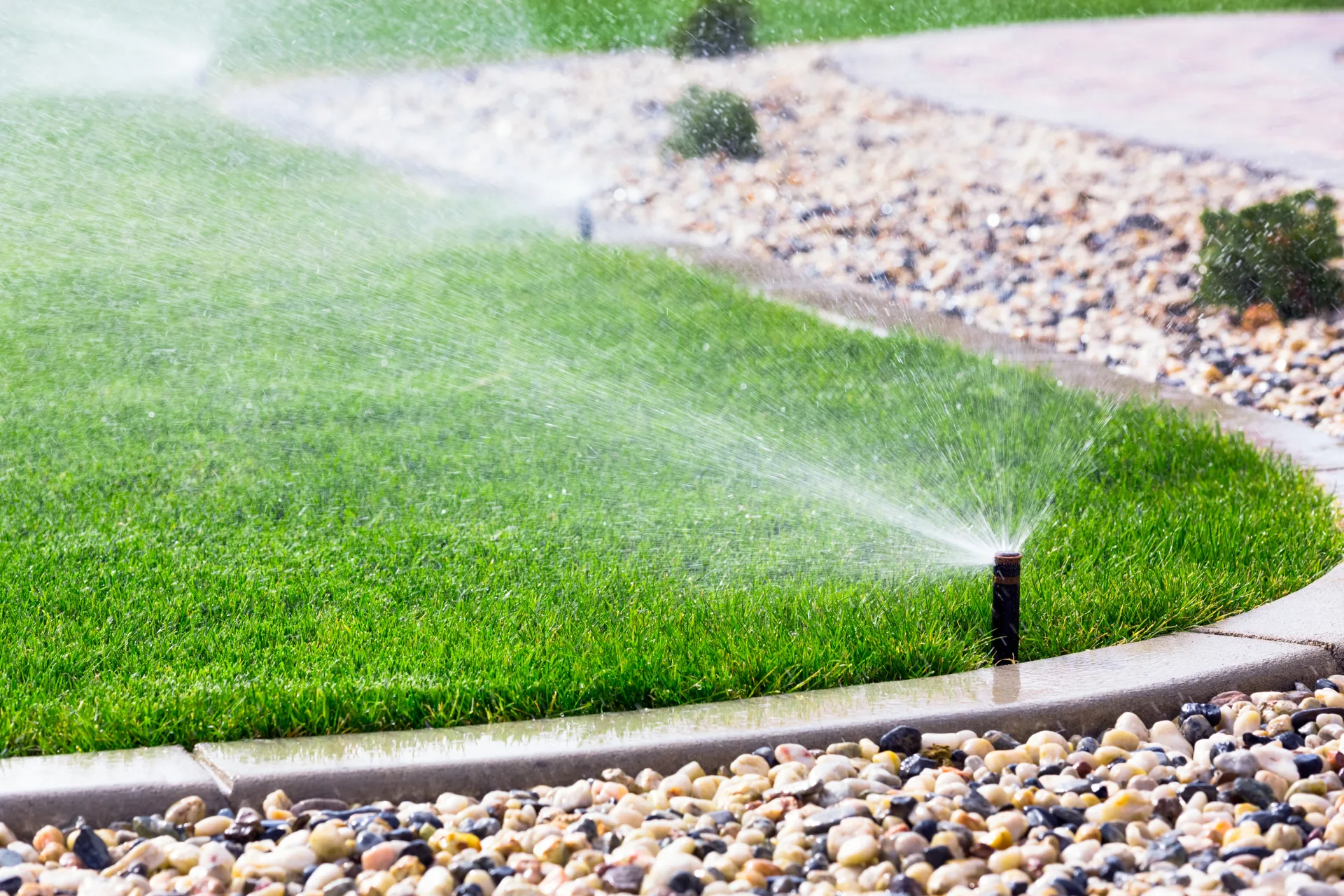 Commercial sprinkler irrigation system watering landscaped property