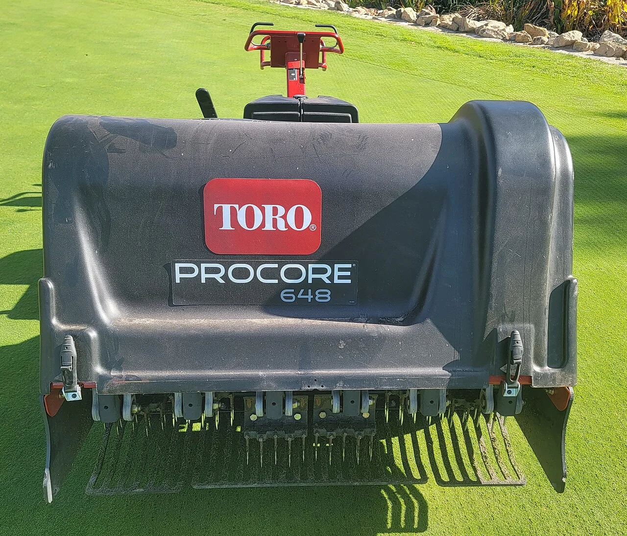Core aeration machine showing the hollow tines used on turf